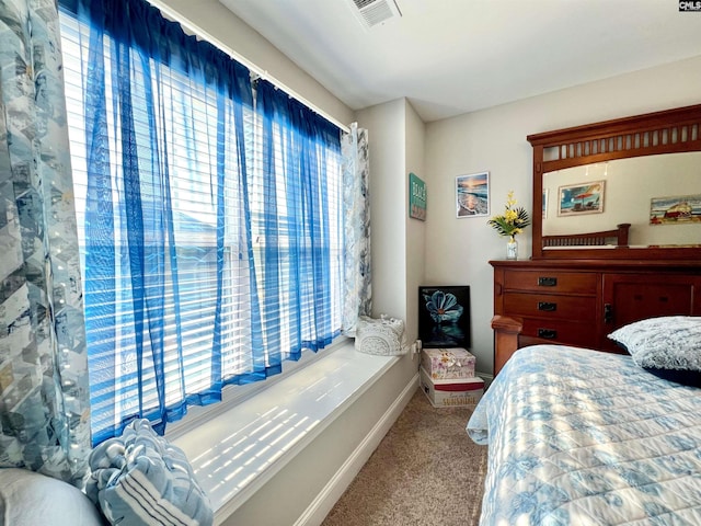 bedroom with visible vents, carpet floors, and baseboards