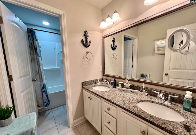 bathroom featuring tile patterned flooring, double vanity, shower / tub combo with curtain, and a sink