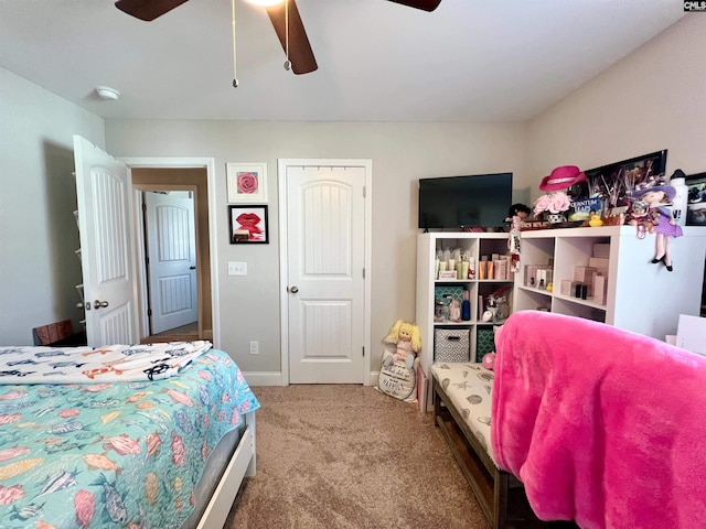 carpeted bedroom with baseboards and ceiling fan