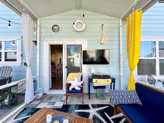 sunroom featuring lofted ceiling