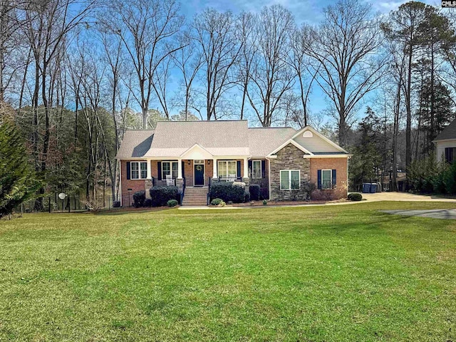 ranch-style home featuring brick siding and a front yard