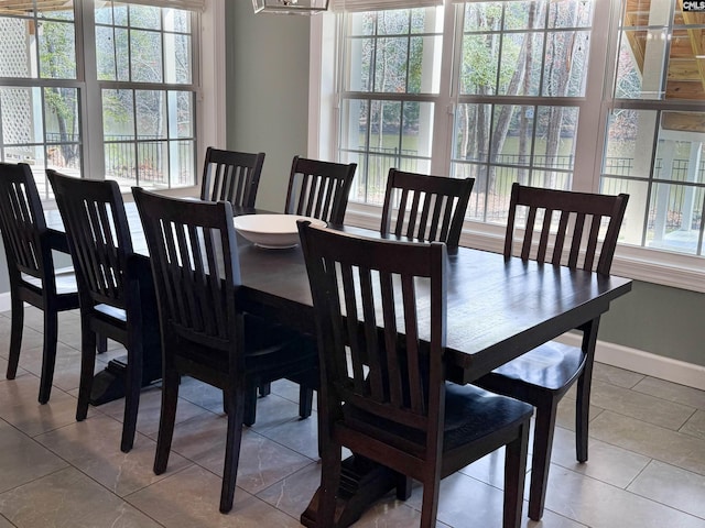 dining space featuring tile patterned floors and baseboards