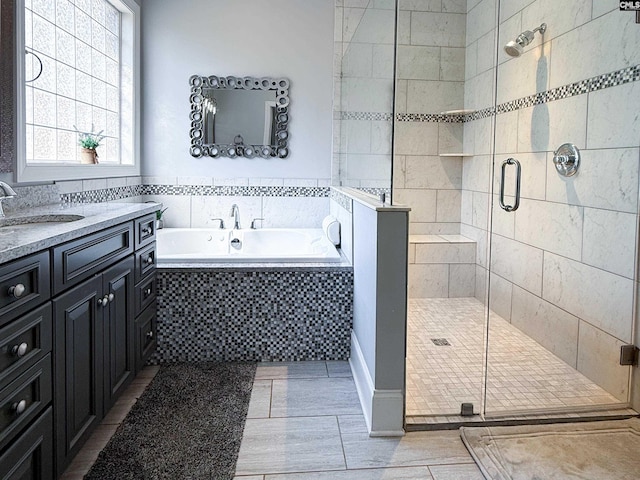 bathroom featuring vanity, a bath, and a stall shower