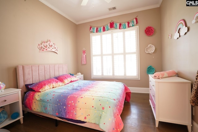 bedroom featuring visible vents, crown molding, baseboards, and wood finished floors