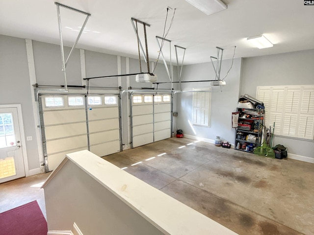 garage with baseboards and a garage door opener