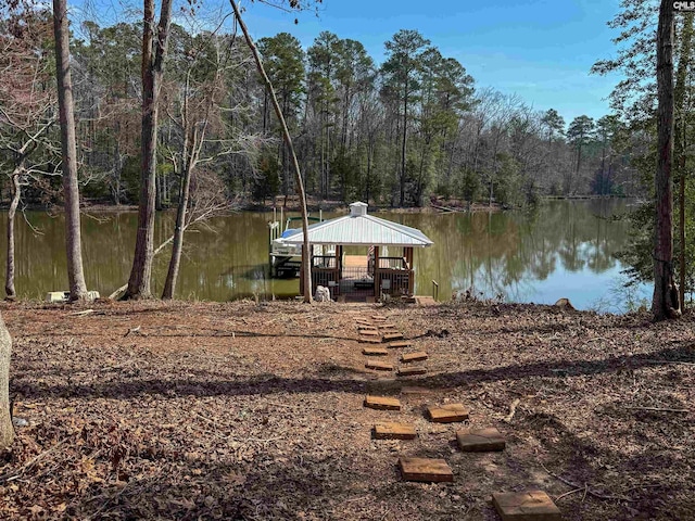 view of dock featuring a water view and a wooded view