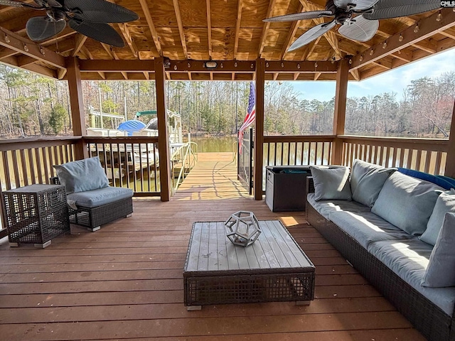 deck with an outdoor hangout area and ceiling fan