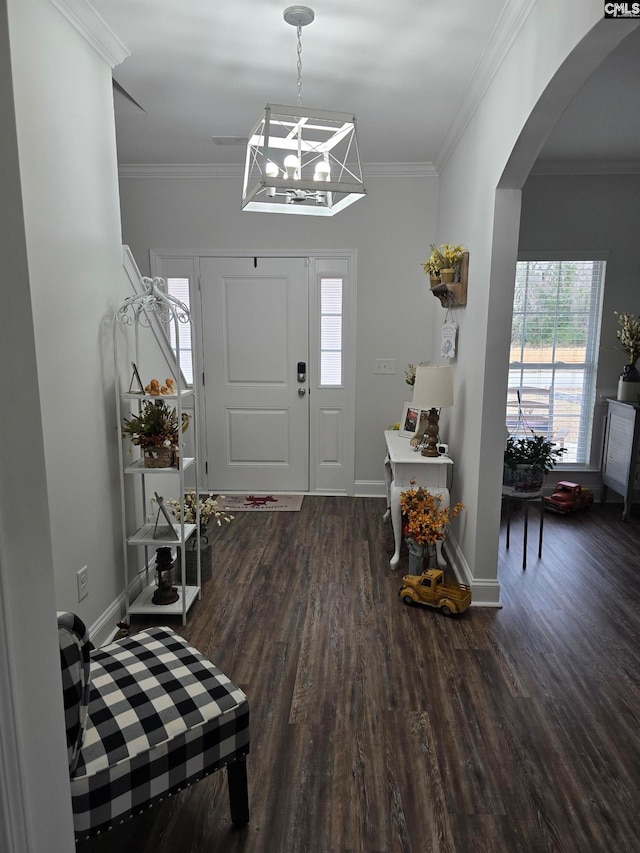 foyer with arched walkways, wood finished floors, and ornamental molding