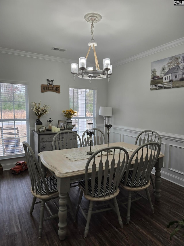 dining space with a notable chandelier, wood finished floors, visible vents, and plenty of natural light