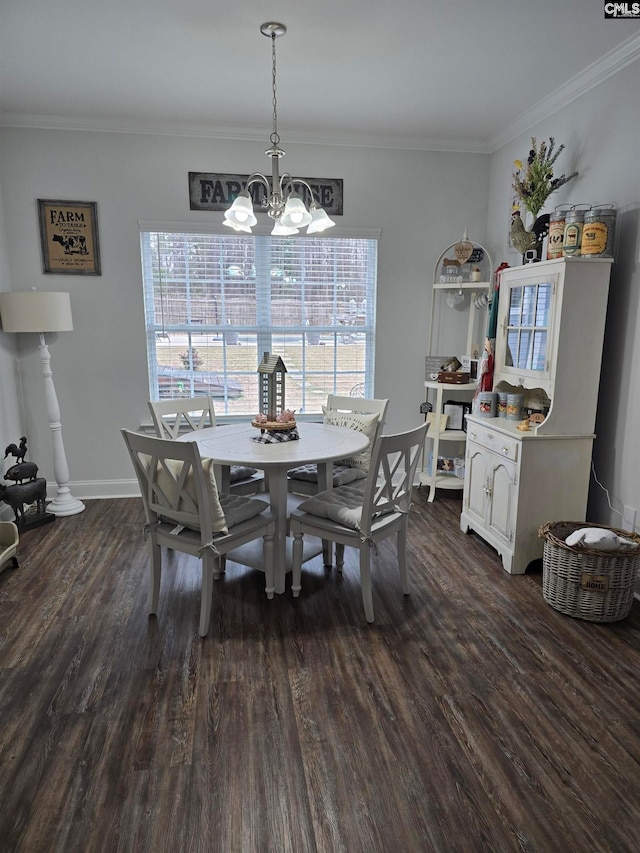 dining room with a chandelier, crown molding, dark wood-type flooring, and baseboards