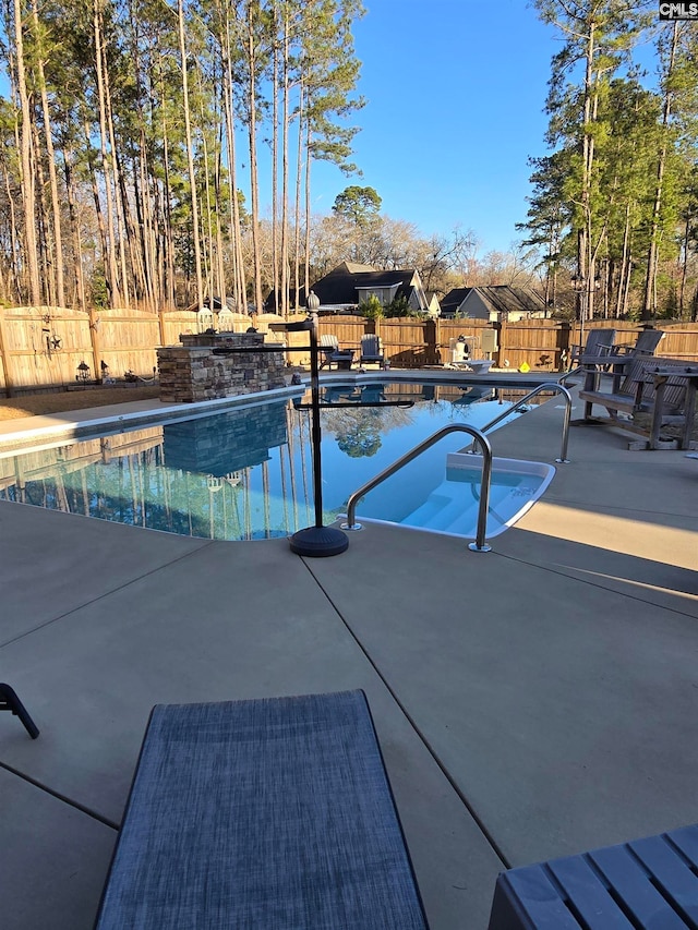 view of swimming pool featuring a patio area, a fenced in pool, and a fenced backyard