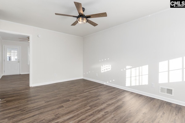 empty room with dark wood-style floors, visible vents, ornamental molding, and a ceiling fan