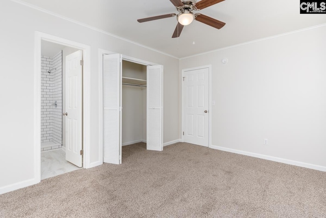 unfurnished bedroom featuring a closet, carpet floors, ensuite bathroom, and crown molding