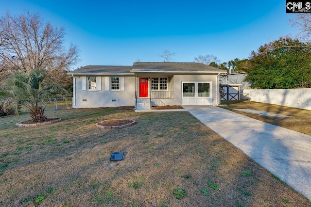 ranch-style home with a gate, driveway, a front yard, and fence