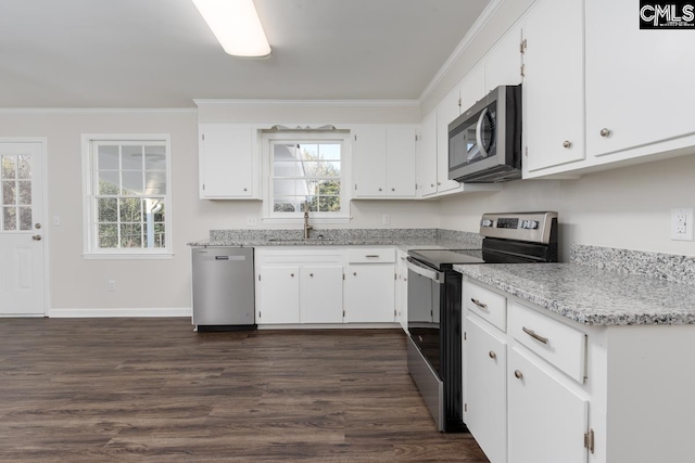 kitchen with appliances with stainless steel finishes, white cabinetry, crown molding, and a sink