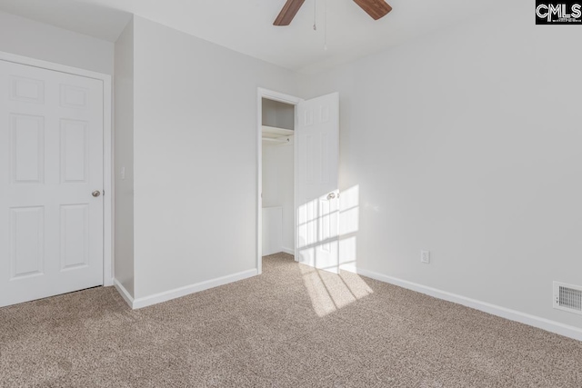 unfurnished bedroom with visible vents, carpet flooring, baseboards, and ceiling fan