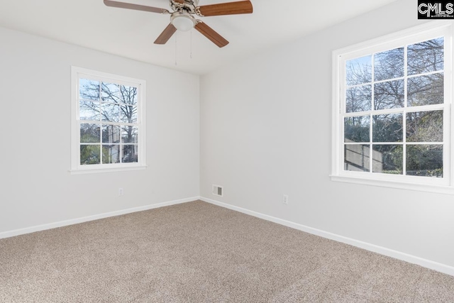 unfurnished room featuring visible vents, ceiling fan, baseboards, and carpet