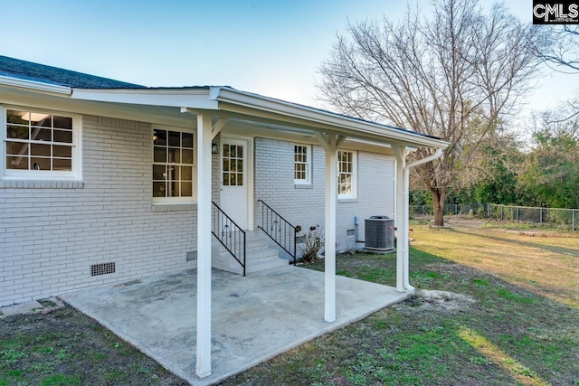 exterior space with cooling unit, entry steps, and fence