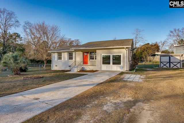 view of front facade featuring a front lawn, a shed, fence, an outdoor structure, and brick siding