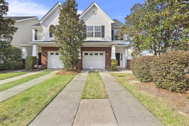 view of front facade with a garage, brick siding, and driveway