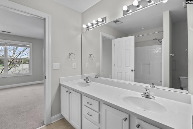 full bathroom featuring a sink, visible vents, toilet, and double vanity