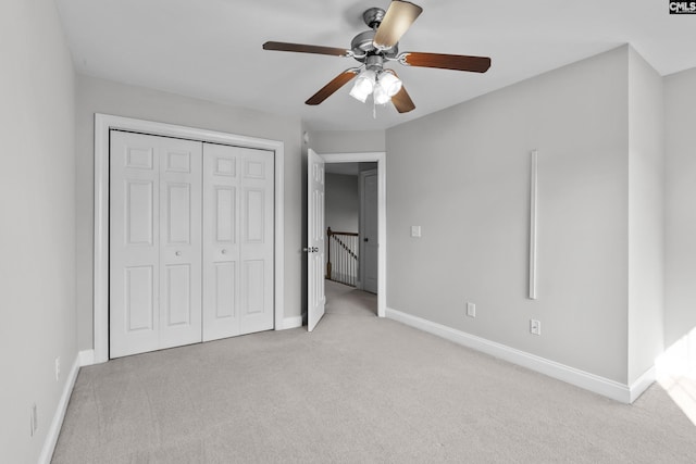 unfurnished bedroom with a closet, ceiling fan, baseboards, and carpet floors