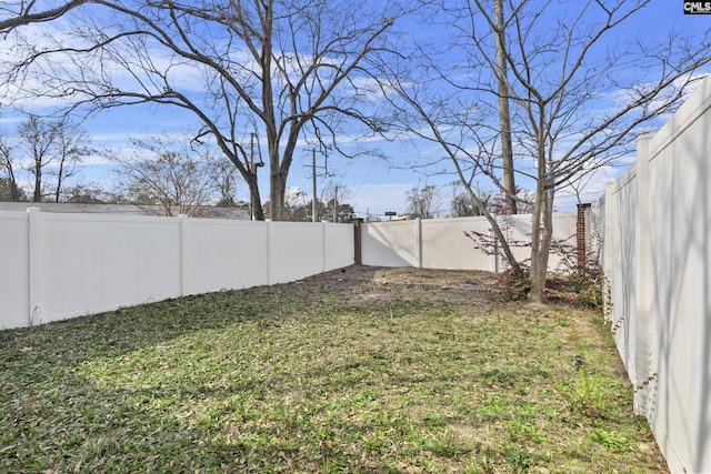 view of yard with a fenced backyard