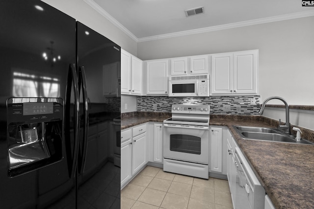 kitchen with dark countertops, visible vents, ornamental molding, white appliances, and a sink