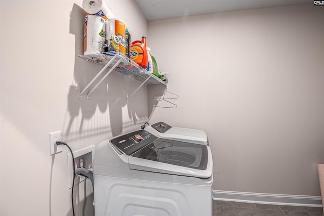 clothes washing area featuring tile patterned floors, laundry area, independent washer and dryer, and baseboards