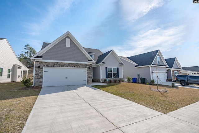 view of front of home with stone siding, a garage, driveway, and a front yard