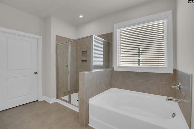 full bath featuring tile patterned floors, recessed lighting, a bath, and a shower stall