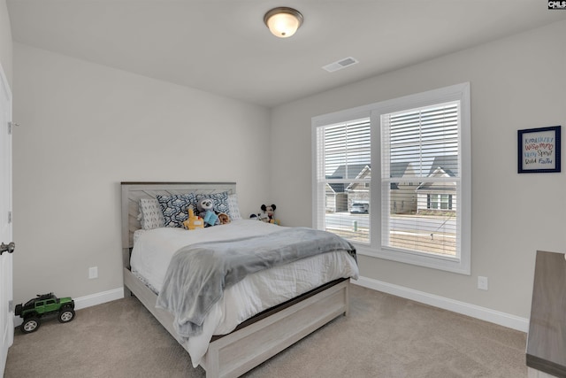 carpeted bedroom featuring visible vents and baseboards