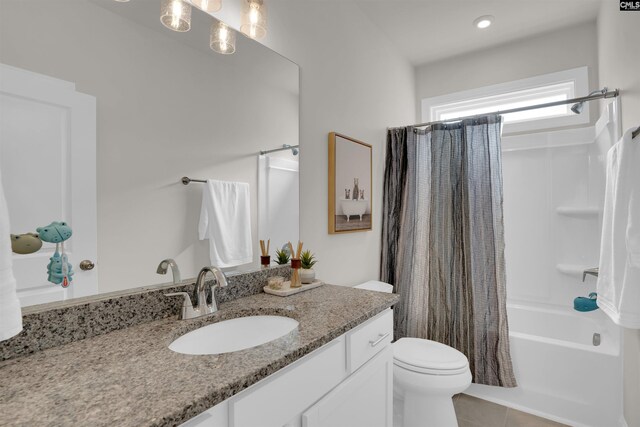 full bath with vanity, tile patterned floors, toilet, and shower / bath combo