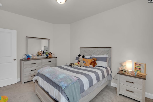 bedroom featuring light colored carpet and baseboards