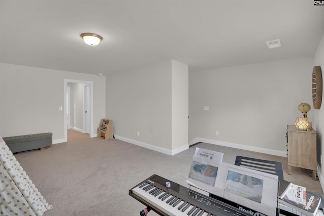 interior space featuring baseboards, carpet floors, and visible vents