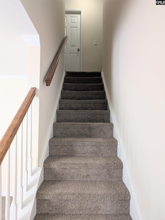 stairway featuring baseboards