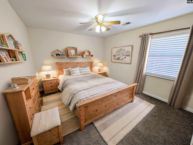 bedroom featuring visible vents, light colored carpet, a ceiling fan, and baseboards