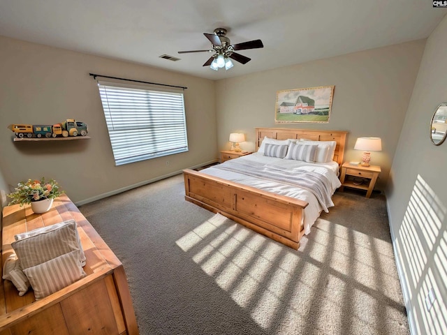 carpeted bedroom with visible vents, baseboards, and ceiling fan