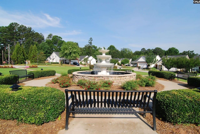 view of property's community with a yard and fence