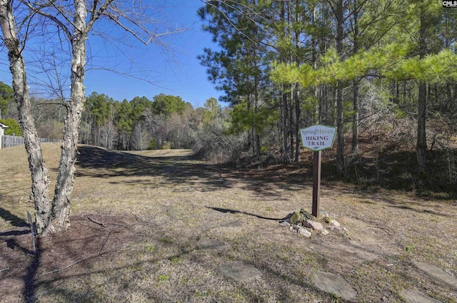 view of yard featuring a forest view