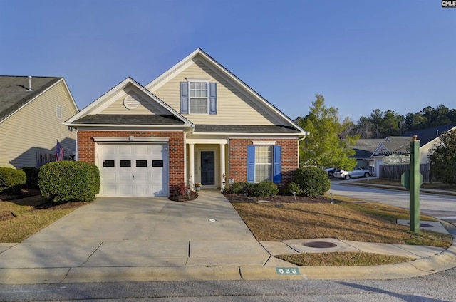 view of front of home with brick siding, an attached garage, and driveway