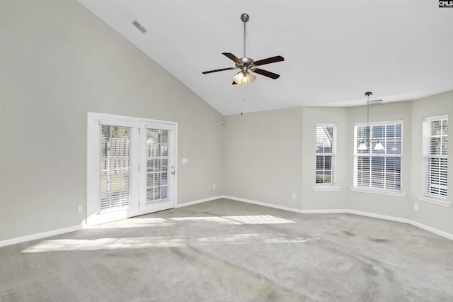 empty room with visible vents, plenty of natural light, carpet floors, and a ceiling fan