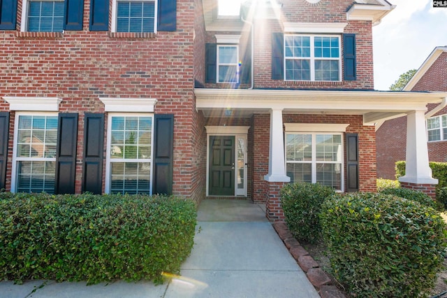 property entrance featuring brick siding