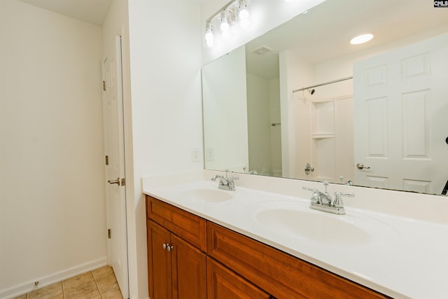 full bathroom with tile patterned flooring, double vanity, visible vents, and a sink