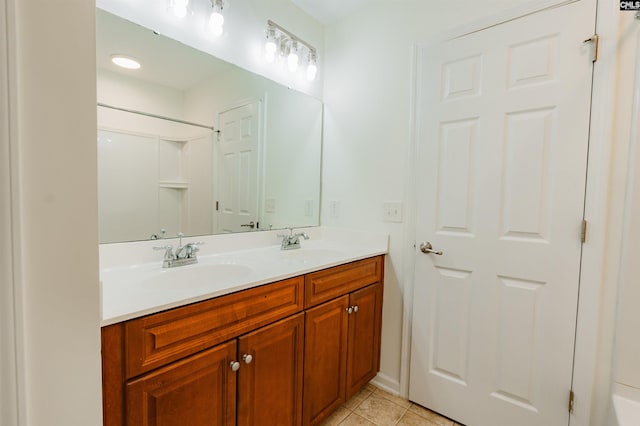 full bathroom with tile patterned floors, double vanity, and a sink