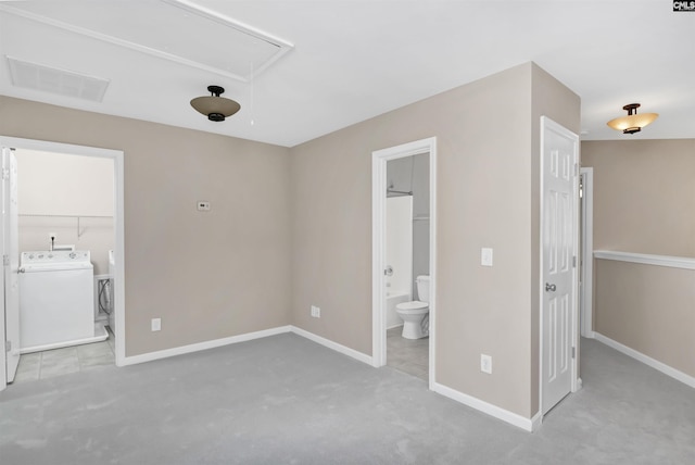 unfurnished bedroom with visible vents, attic access, ensuite bathroom, and baseboards