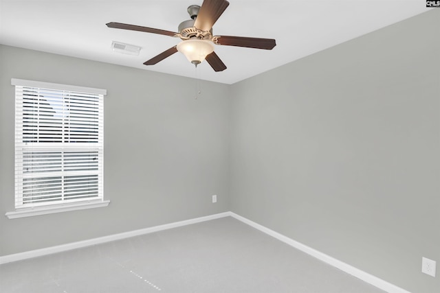 spare room with baseboards, visible vents, and ceiling fan