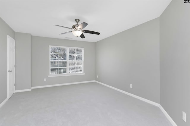 spare room with baseboards, carpet, and ceiling fan