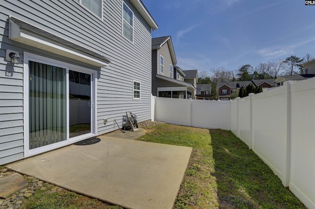 view of yard with a residential view, a patio, and a fenced backyard