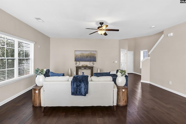 living room with baseboards, wood finished floors, and ceiling fan